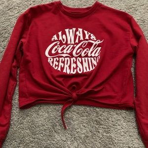 A long sleeve red Coca-Cola crop top